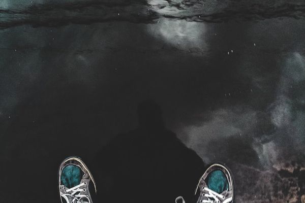 Smiling person standing in nature after exercise