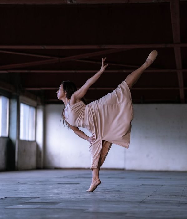 Woman practicing dynamic movement in a bright minimal studio